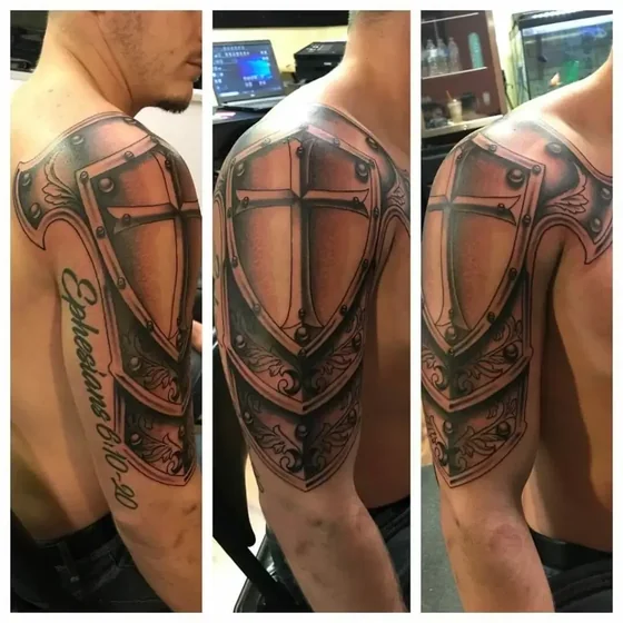 Realistic armor shield cross tattoo design for men on shoulder