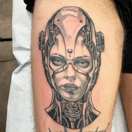Realistic biomechanical cyborg woman tattoo design for men on thigh