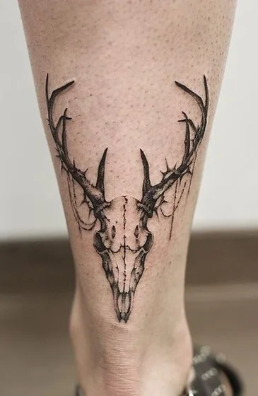 Realistic black and grey deer skull tattoo design for men and women on calf