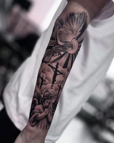 Realistic black and grey dove, cross, angel tattoo for men on forearm
