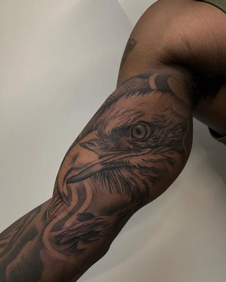Realistic black and grey eagle tattoo for men on upper arm