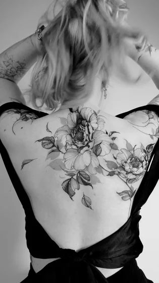 Realistic black and grey floral tattoo for women on back
