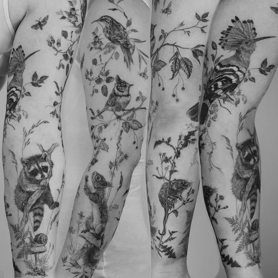 Realistic black and grey full sleeve tattoo for women: birds, floral.