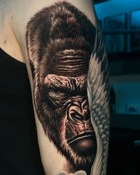 Realistic black and grey gorilla tattoo design for men on upper arm
