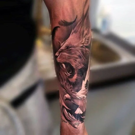 Realistic black and grey lion and dove tattoo for men on forearm