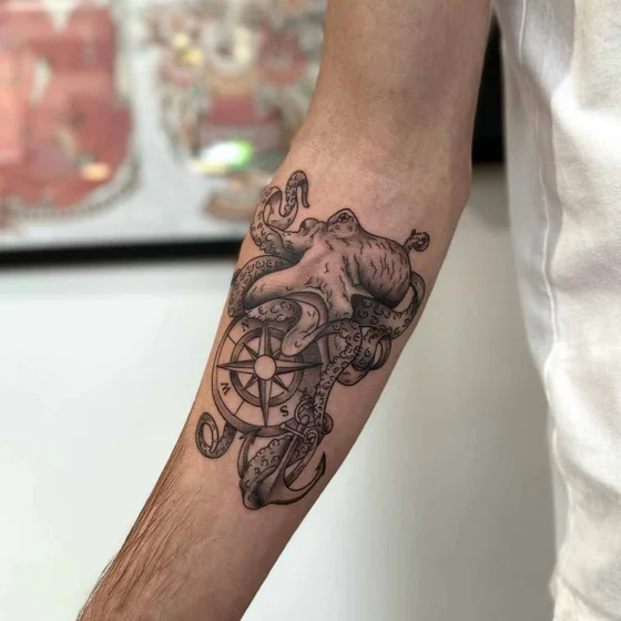 Realistic black and grey octopus, compass, anchor tattoo design for men on forearm