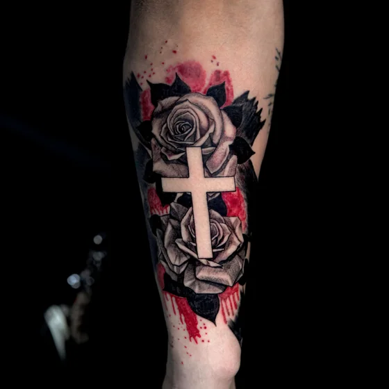 Realistic black and grey rose and cross tattoo design for men on forearm