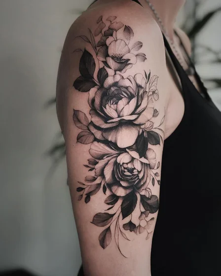Realistic black and grey rose floral tattoo design for women on upper arm