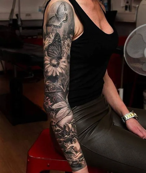 Realistic butterfly and floral full sleeve tattoo idea for women