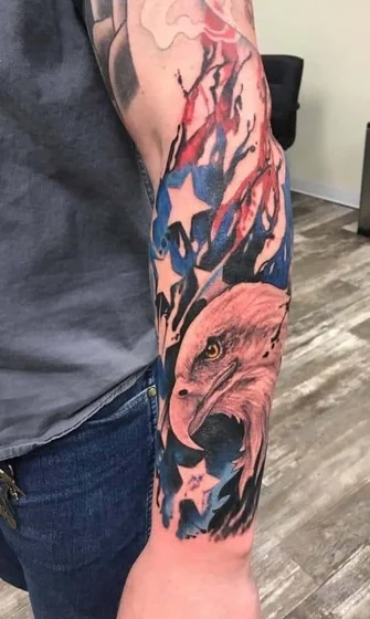 Realistic eagle and American flag watercolor tattoo design for men on forearm