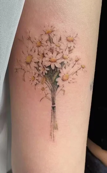Realistic fine line daisy bouquet tattoo design for women on upper arm