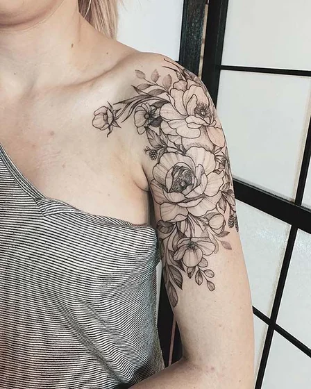 Realistic fine line floral tattoo idea for women on shoulder