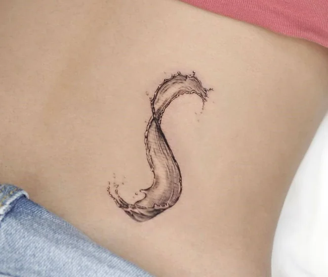Realistic fine line water splash 'S' initial tattoo design for women on hip