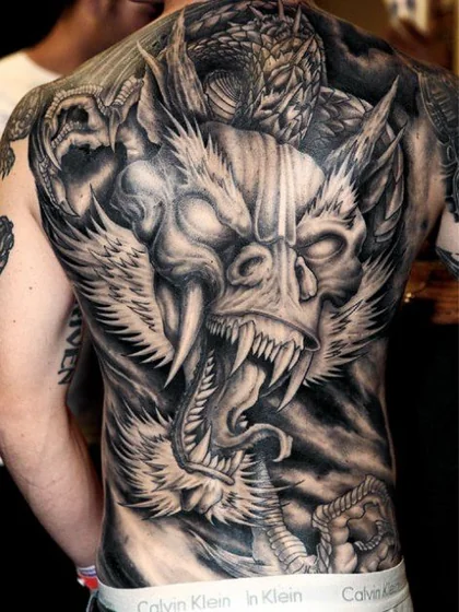 Realistic horror dragon skull wing tattoo for men on back and shoulder
