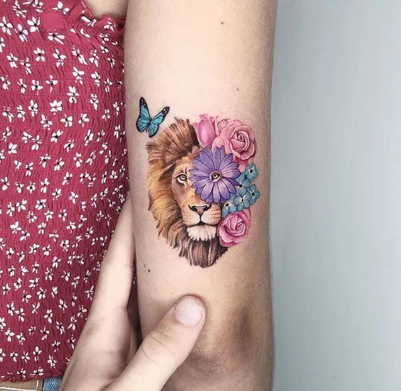 Realistic lion and floral tattoo idea for women on upper arm