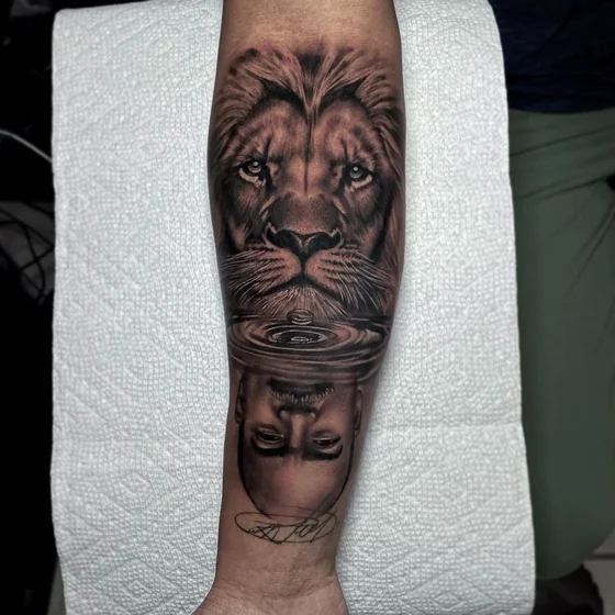Realistic lion and human reflection tattoo for men on forearm