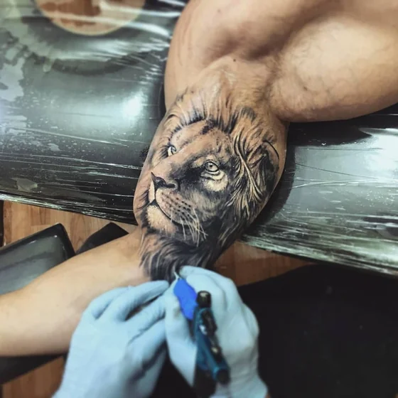 Realistic lion tattoo design for men on upper arm