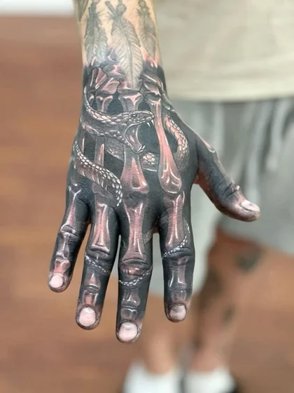 Realistic snake and skeleton tattoo idea for men on hand