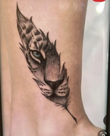 Realistic tiger and feather tattoo design on ankle