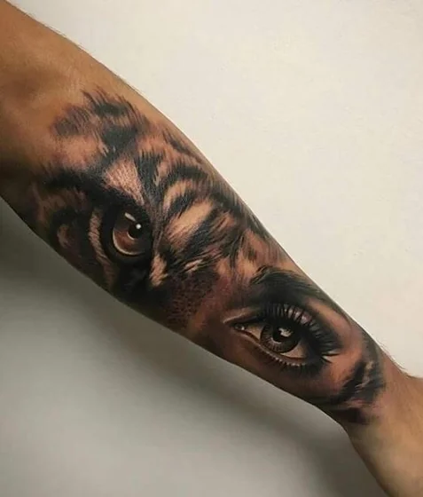 Realistic tiger and human eye tattoo design for men on forearm
