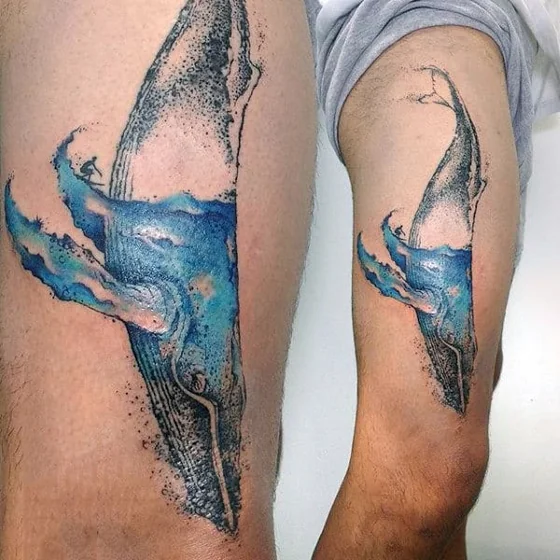 Realistic watercolor whale and surfer ocean tattoo design for men on thigh