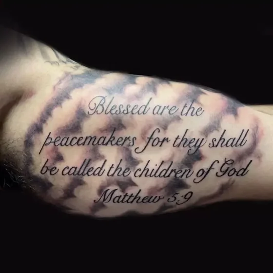 Script Black And Grey religious quote cloud tattoo design for men on upper arm
