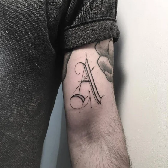 Script and fine line Letter A tattoo design for men on upper arm