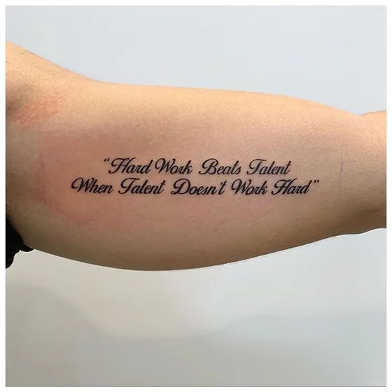 Script quote tattoo design for men on bicep tattoo ideas