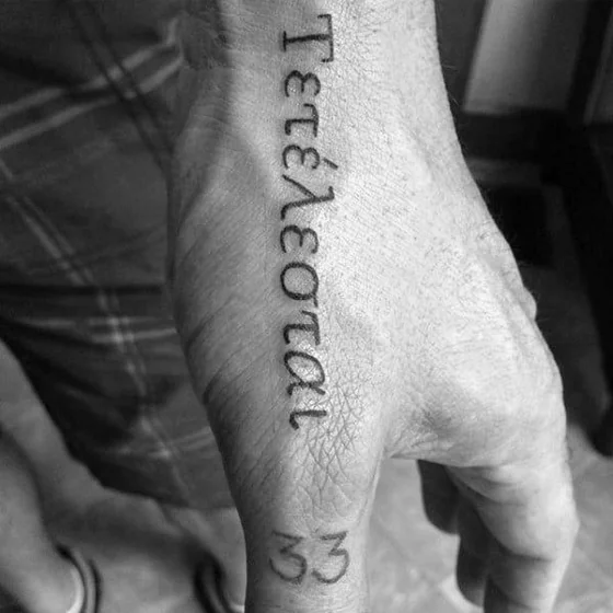 Script word and numbers tattoo design for men on hand