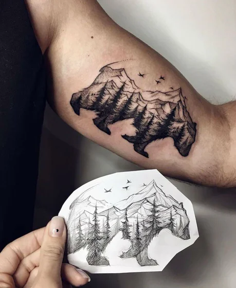 Sketch fine line bear, mountain, tree tattoo design for men on upper arm.