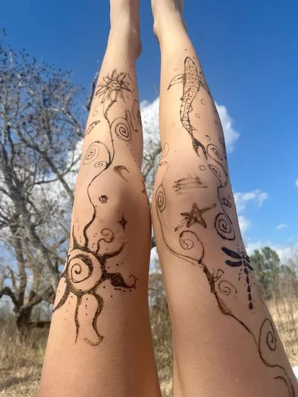 Sketch linework flower, floral, and sun tattoo design for women on leg