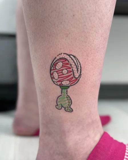 Sketchy Ignorant Piranha Plant video game tattoo for women on calf