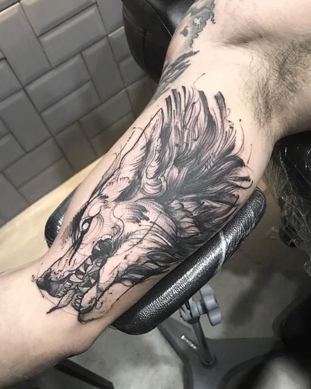 Sketchy black and grey wolf tattoo design for men on forearm