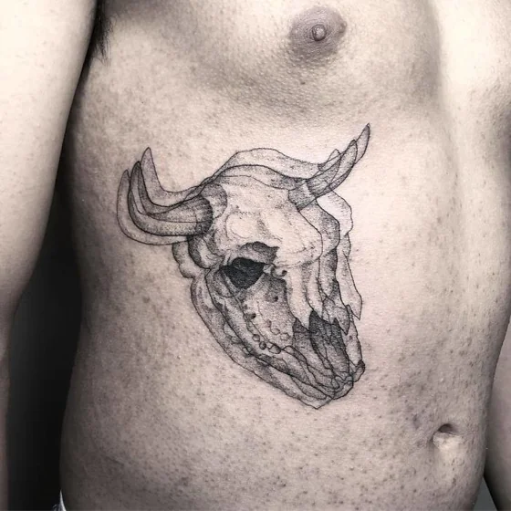 Sketchy dotwork skull tattoo idea for men on rib