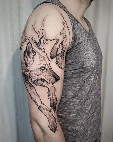 Sketchy linework wolf tattoo idea for men on upper arm and shoulder