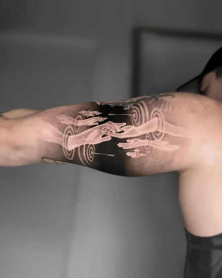 Surreal Realism hands and energy rings tattoo design for men on upper arm