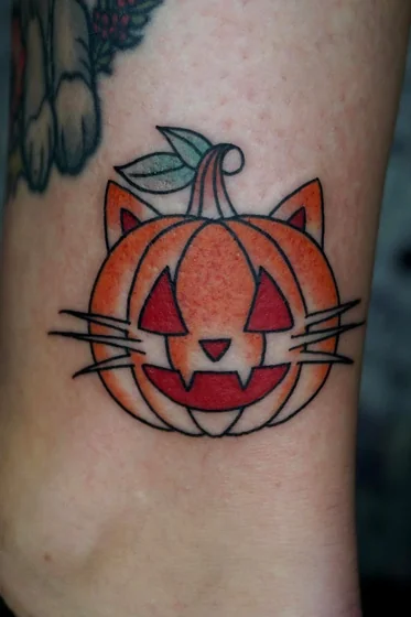 Traditional Halloween cat pumpkin tattoo idea for all genders