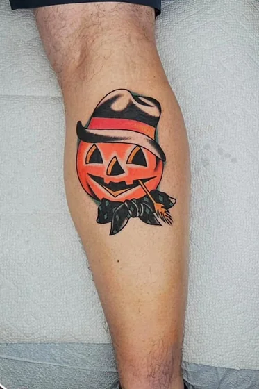 Traditional Halloween jack-o'-lantern tattoo design for men on calf