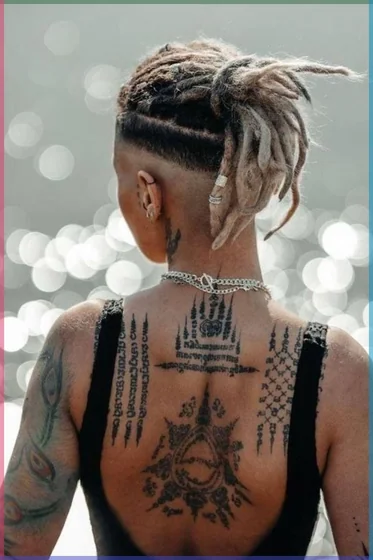 Traditional Sak Yant patchwork tattoo idea for women on back