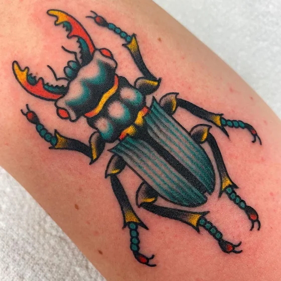 Traditional beetle tattoo design for men and women on arm