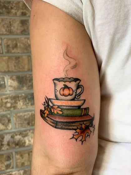 Traditional book, pumpkin, and teacup tattoo design for women on upper arm