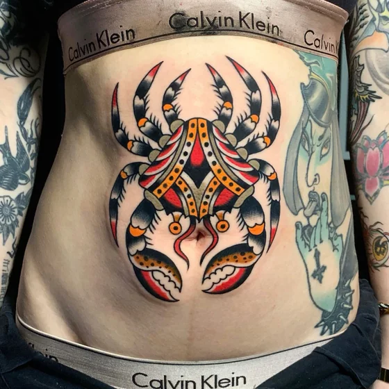 Traditional crab, bird, cross, stylized face patchwork tattoo for women.