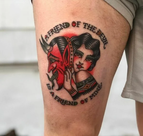 Traditional devil mask and woman quote tattoo design for men on thigh