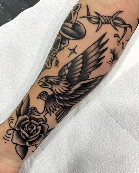 Traditional patchwork eagle, rose, star, barbed wire tattoo idea for men and women on forearm