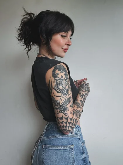 Traditional patchwork full sleeve tattoo for women with tiger, flowers, pin-up girl.