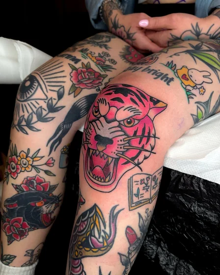 Traditional patchwork tiger, floral tattoos for women on knee and thigh