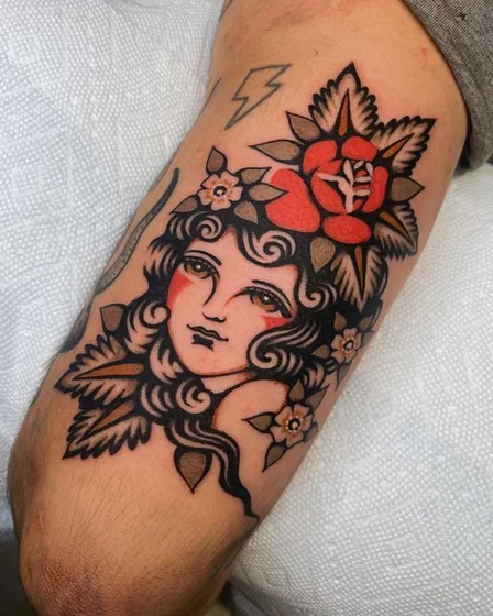 Traditional rose and floral tattoo design for men on upper arm