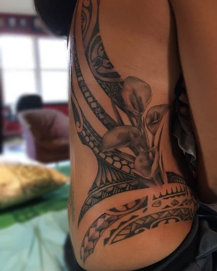 Tribal and realistic floral tattoo design for men and women on rib