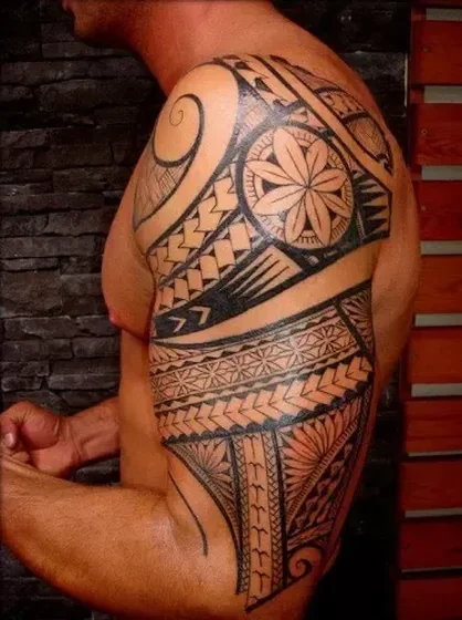Tribal blackwork flower tattoo idea for men on half sleeve upper arm