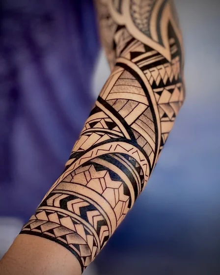 Tribal geometric half sleeve tattoo design for men on forearm